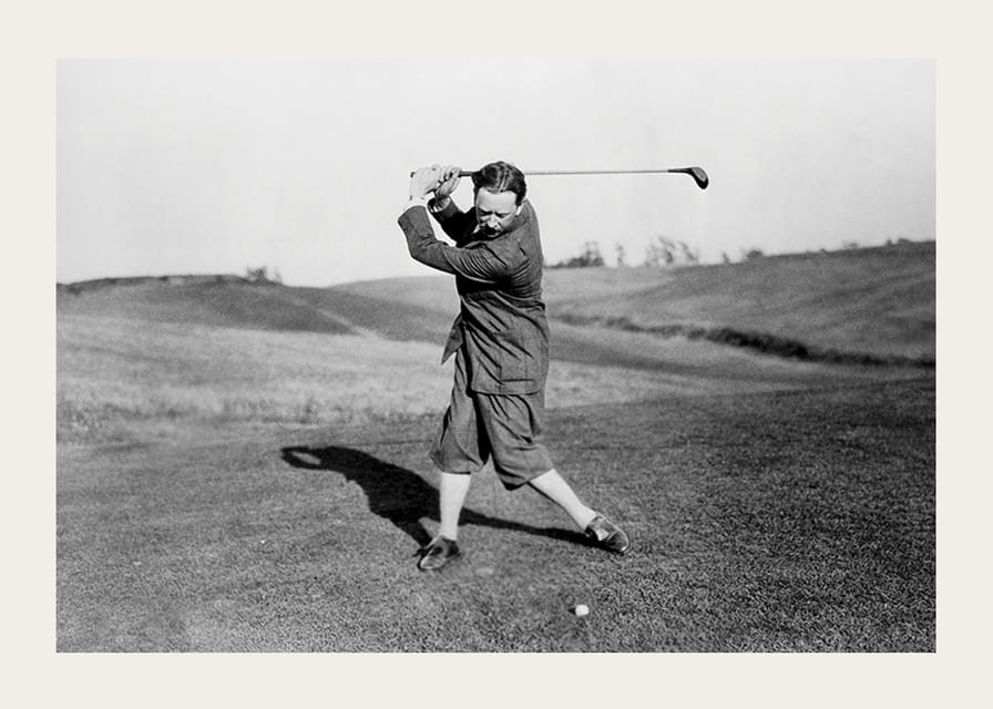 Black and white photograph of male golfer in classic attire-12