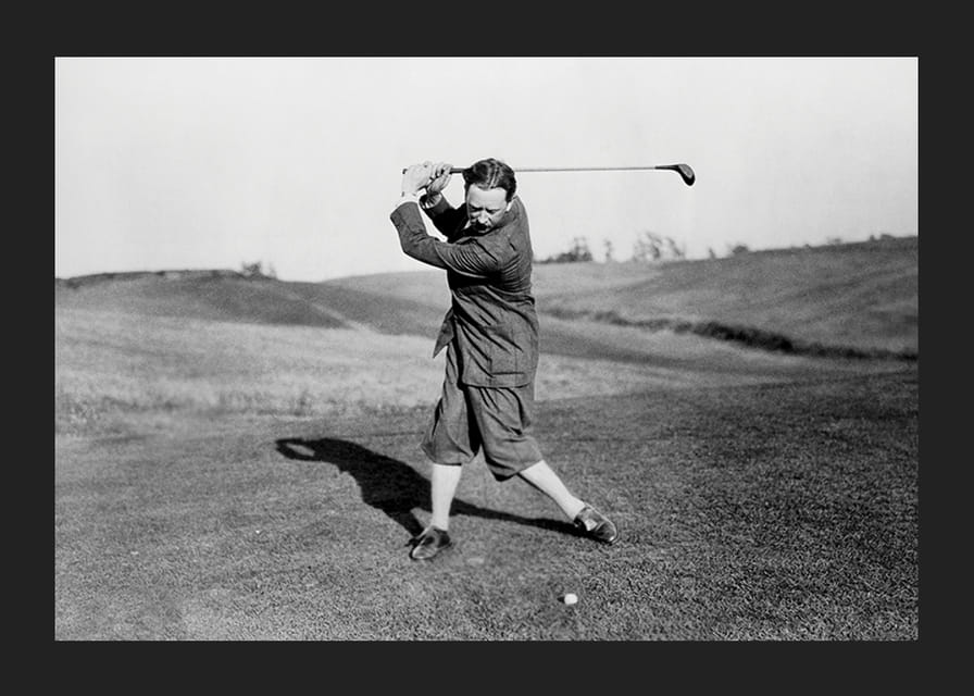 Black and white photograph of male golfer in classic attire-12