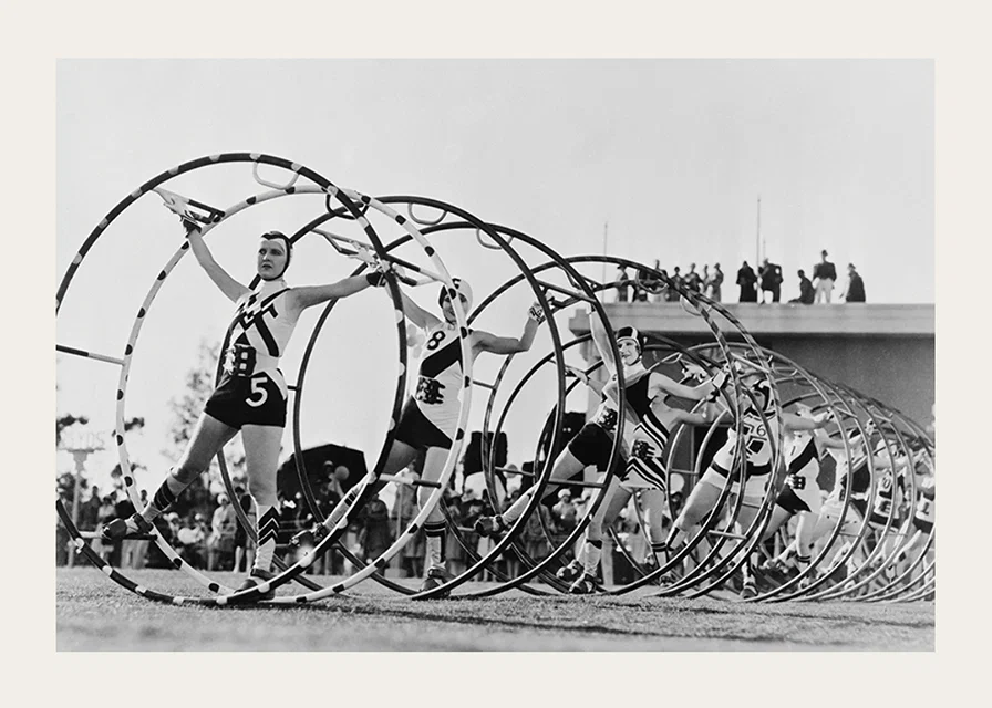 Black and white photo of female gymnasts with large hoops-12