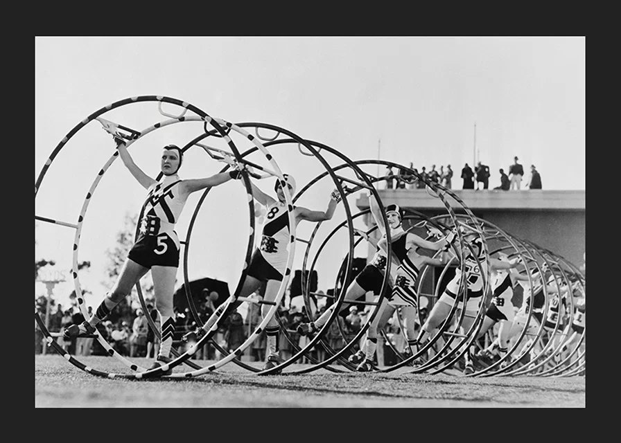Black and white photo of female gymnasts with large hoops-12