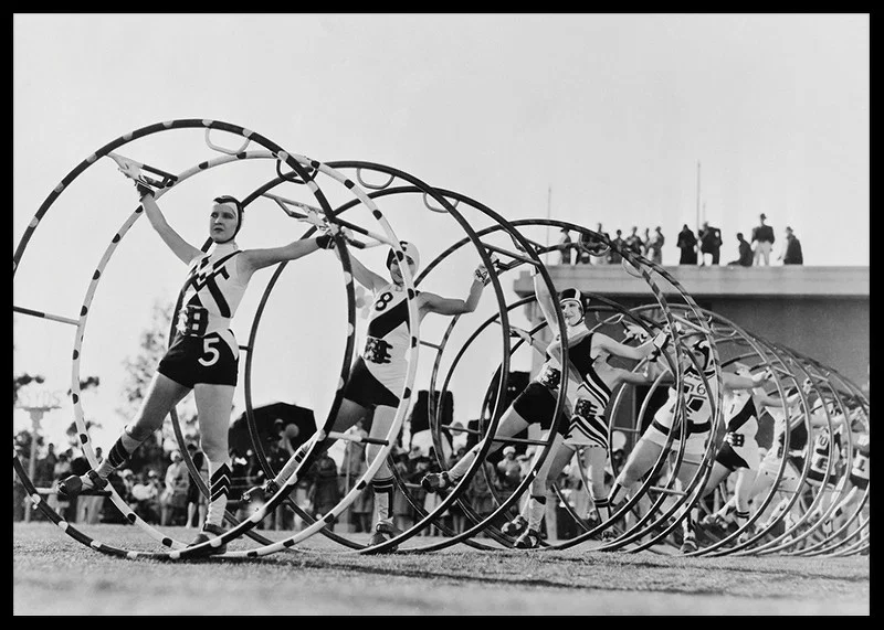Black and white photo of female gymnasts with large hoops-12