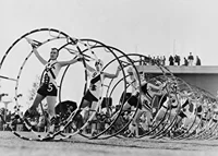 Black and white photo of female gymnasts with large hoops-7