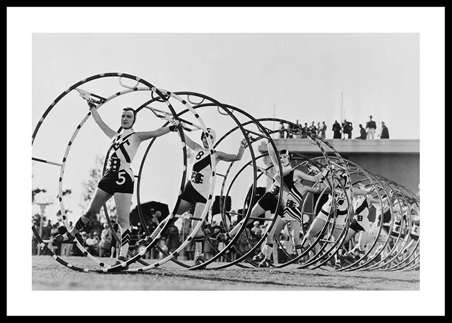 Black and white photo of female gymnasts with large hoops-12