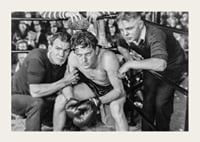 Black and white scene with boxer and two trainers in ring corner-3