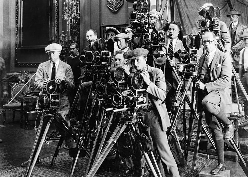 Black and white photo of group of photographers with classic cameras-12