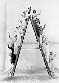 Black and white photograph of women in 1930s clothing on ladder-7