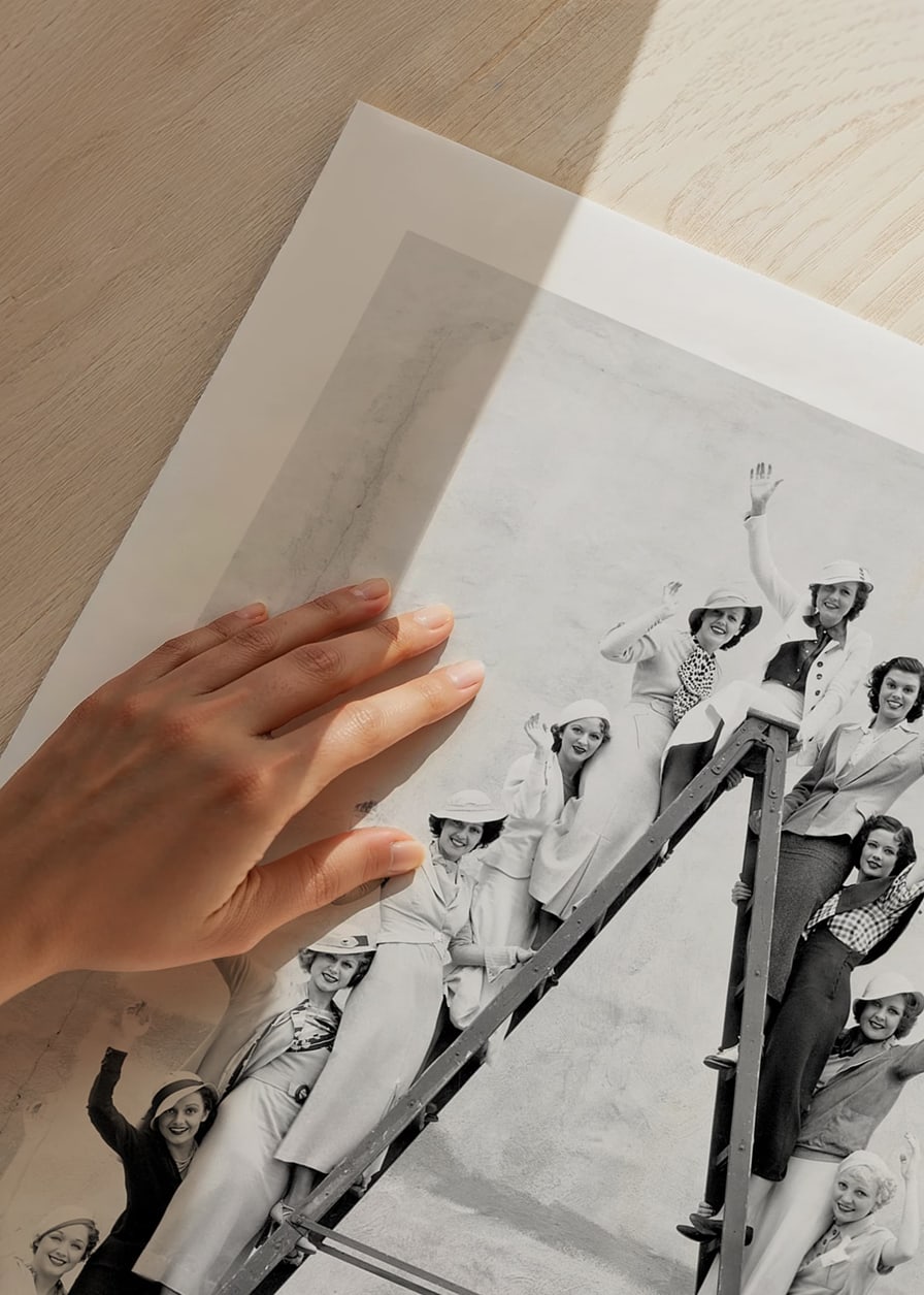 Black and white photograph of women in 1930s clothing on ladder-12