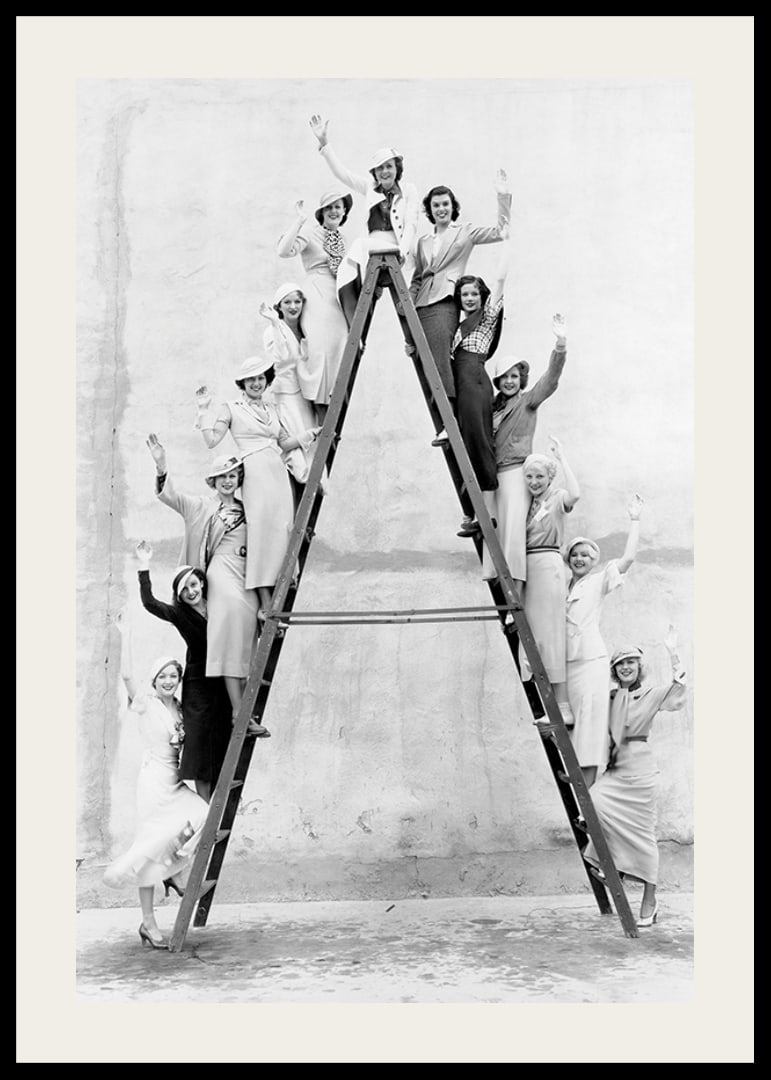 Black and white photograph of women in 1930s clothing on ladder-12