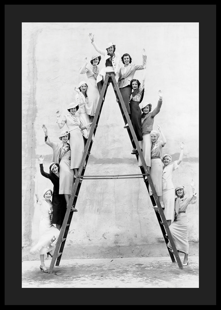 Black and white photograph of women in 1930s clothing on ladder-12