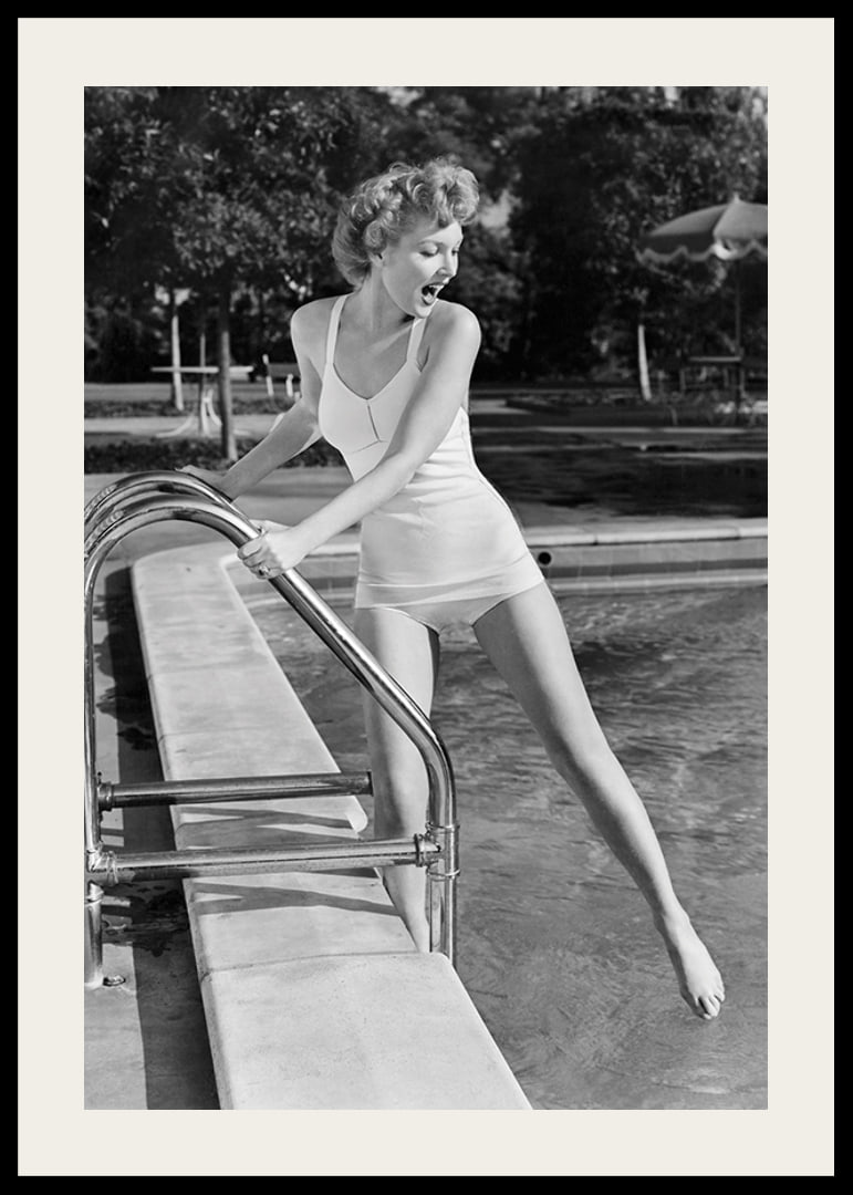 Black and white vintage photograph of woman at poolside in swimsuit-12