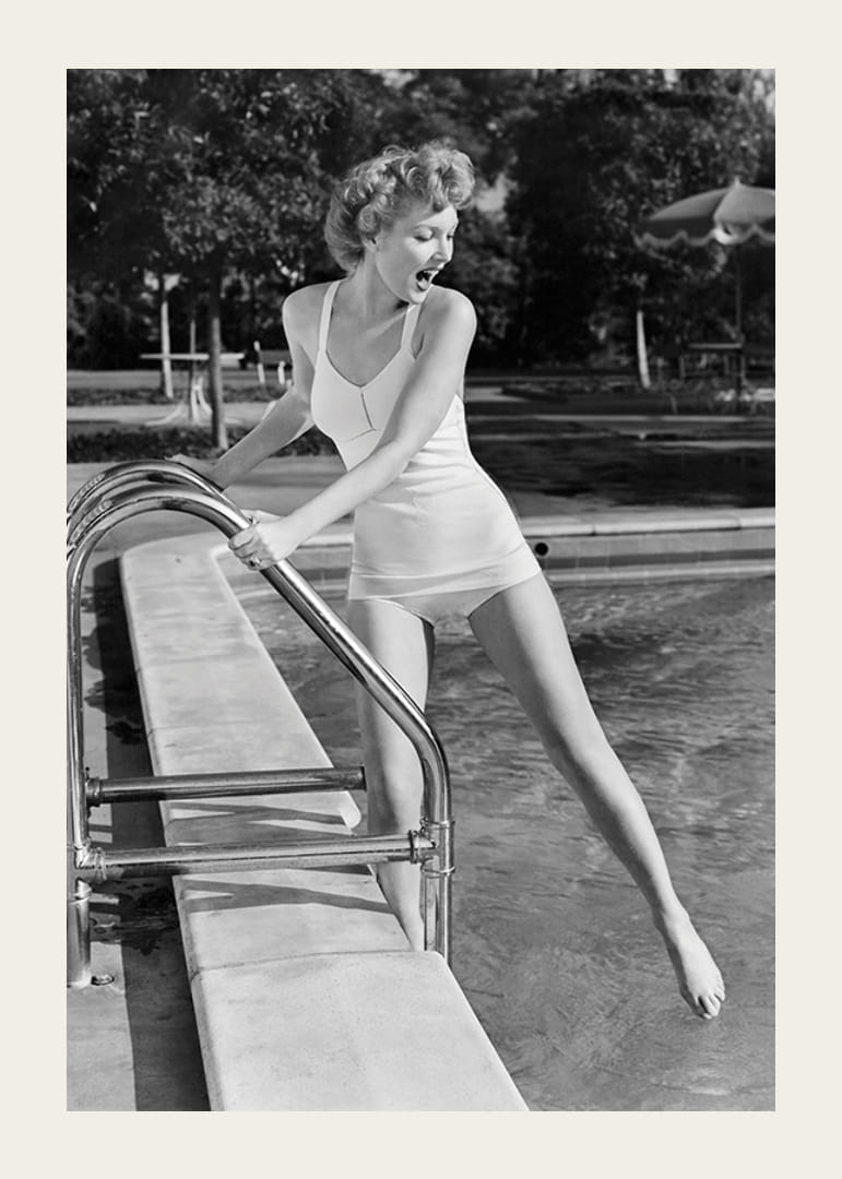 Black and white vintage photograph of woman at poolside in swimsuit-12