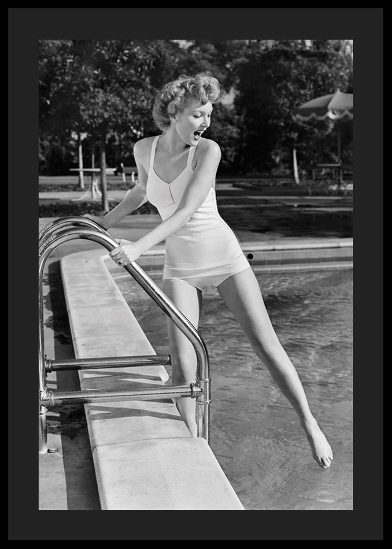 Black and white vintage photograph of woman at poolside in swimsuit-12