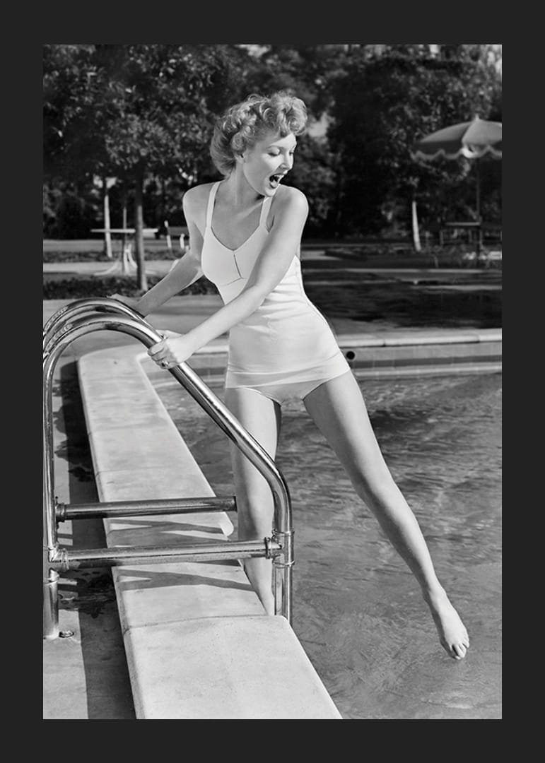 Black and white vintage photograph of woman at poolside in swimsuit-12