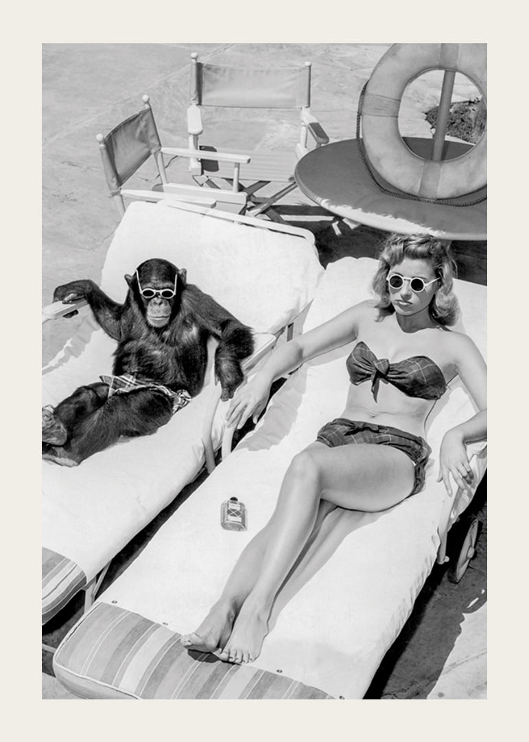 Black and white vintage photograph of woman and chimpanzee by pool-12