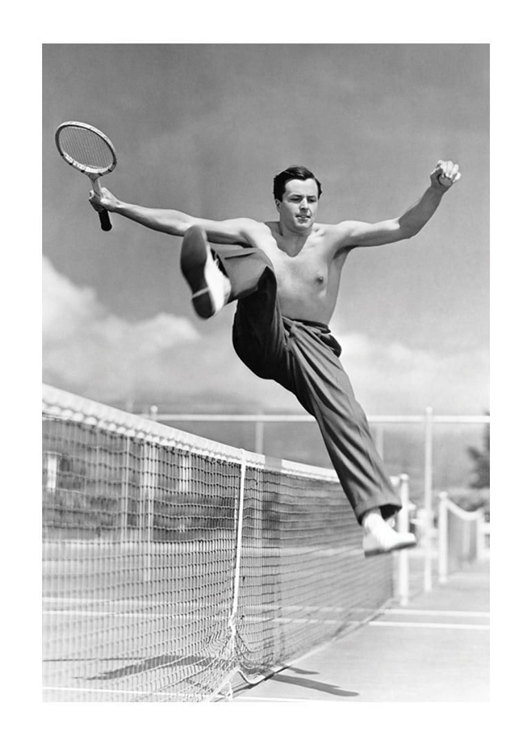 Black and white photo of bare-chested man jumping over tin netting-12