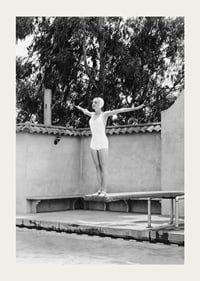 Black and white woman in swimsuit on trampoline at poolside-3