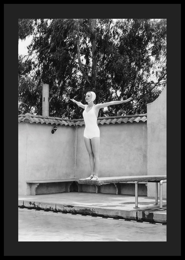 Black and white woman in swimsuit on trampoline at poolside-12