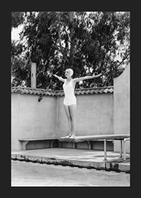 Black and white woman in swimsuit on trampoline at poolside-5