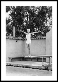 Black and white woman in swimsuit on trampoline at poolside-0