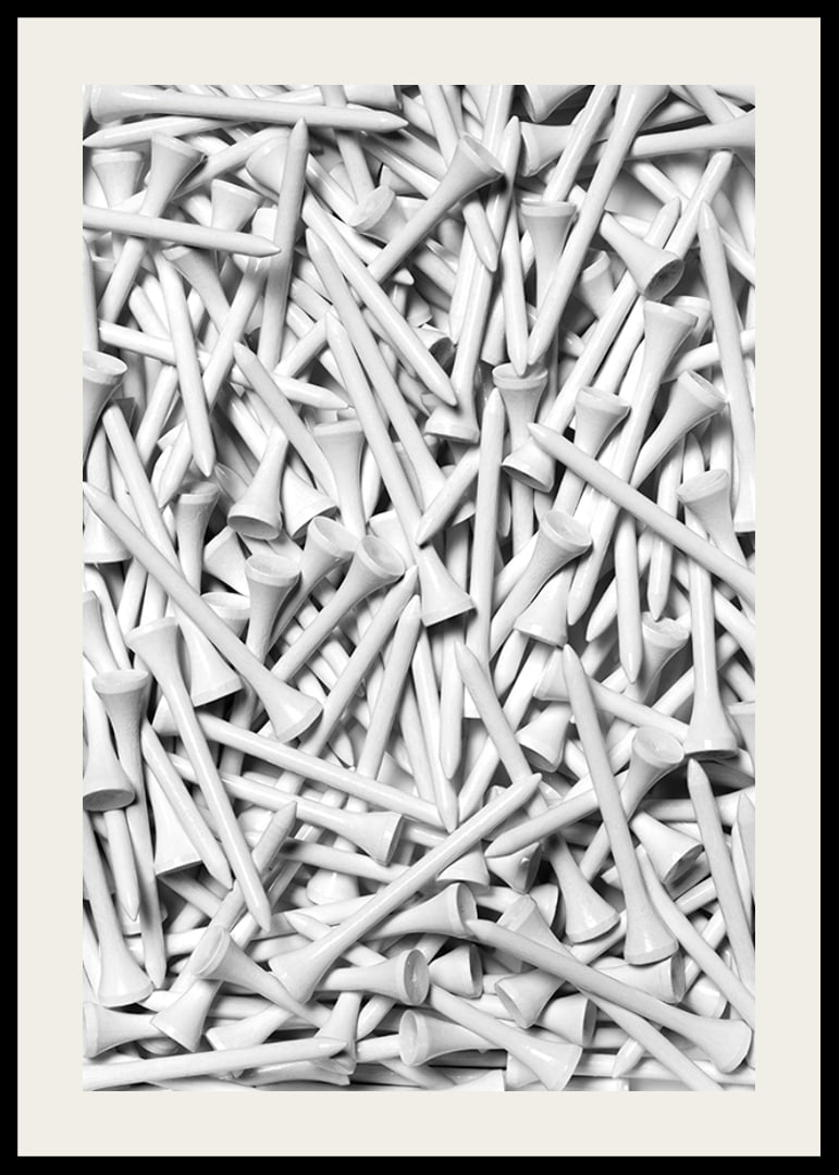 Close-up of white golf pegs in tight composition, black and white-12