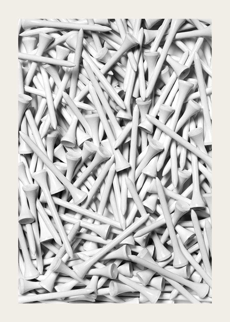 Close-up of white golf pegs in tight composition, black and white-12