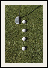 Golf club and four white golf balls on green lawn-2