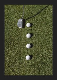Golf club and four white golf balls on green lawn-5