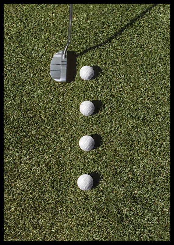 Golf club and four white golf balls on green lawn-12