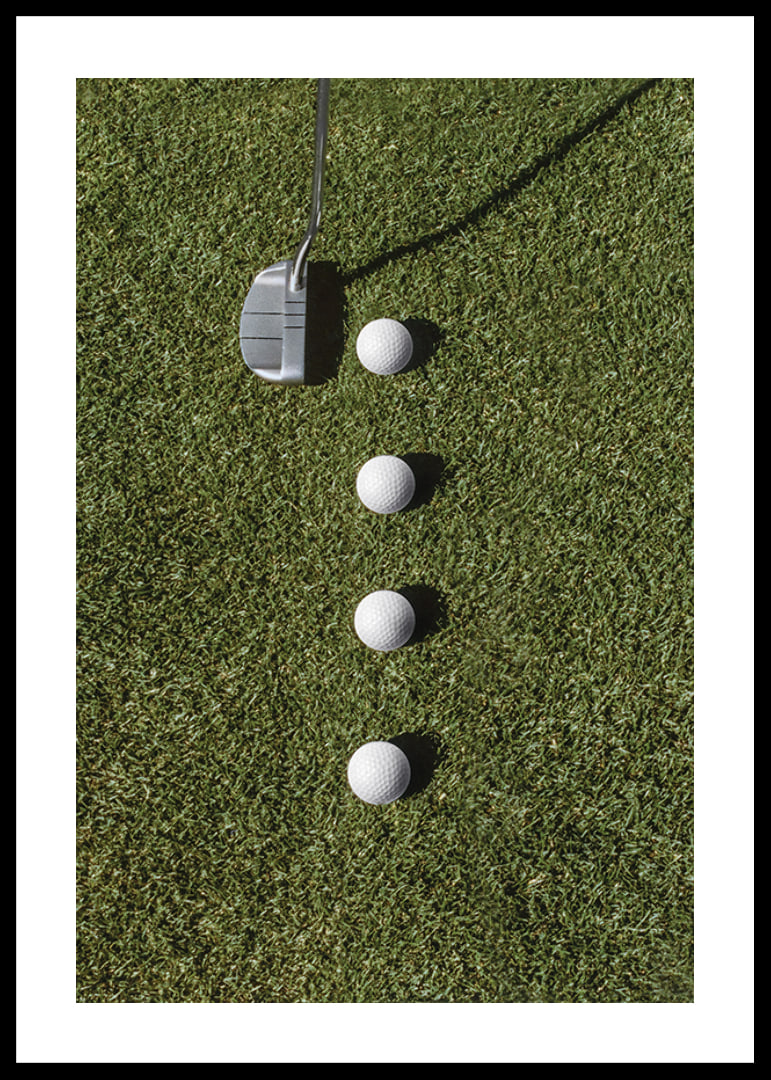 Golf club and four white golf balls on green lawn-12