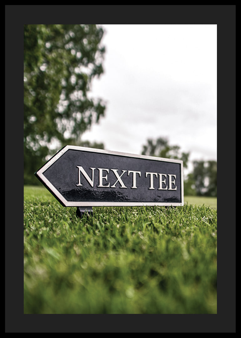 Photographic sign on golf course with the text Next Tee-12