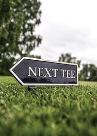 Photographic sign on golf course with the text Next Tee-7