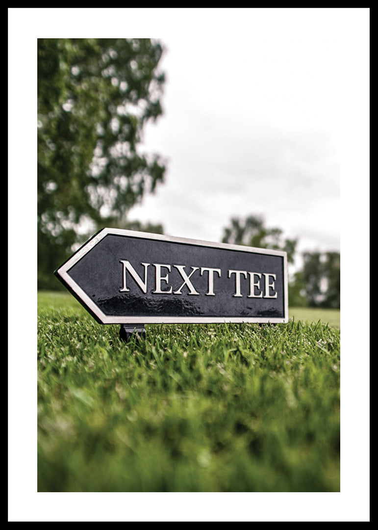 Photographic sign on golf course with the text Next Tee-12