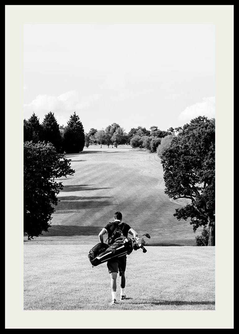 Golfer with bag against fairway in black and white landscape-12