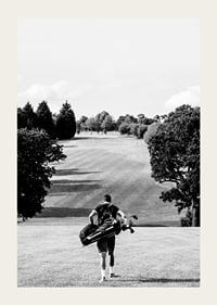 Golfer with bag against fairway in black and white landscape-3