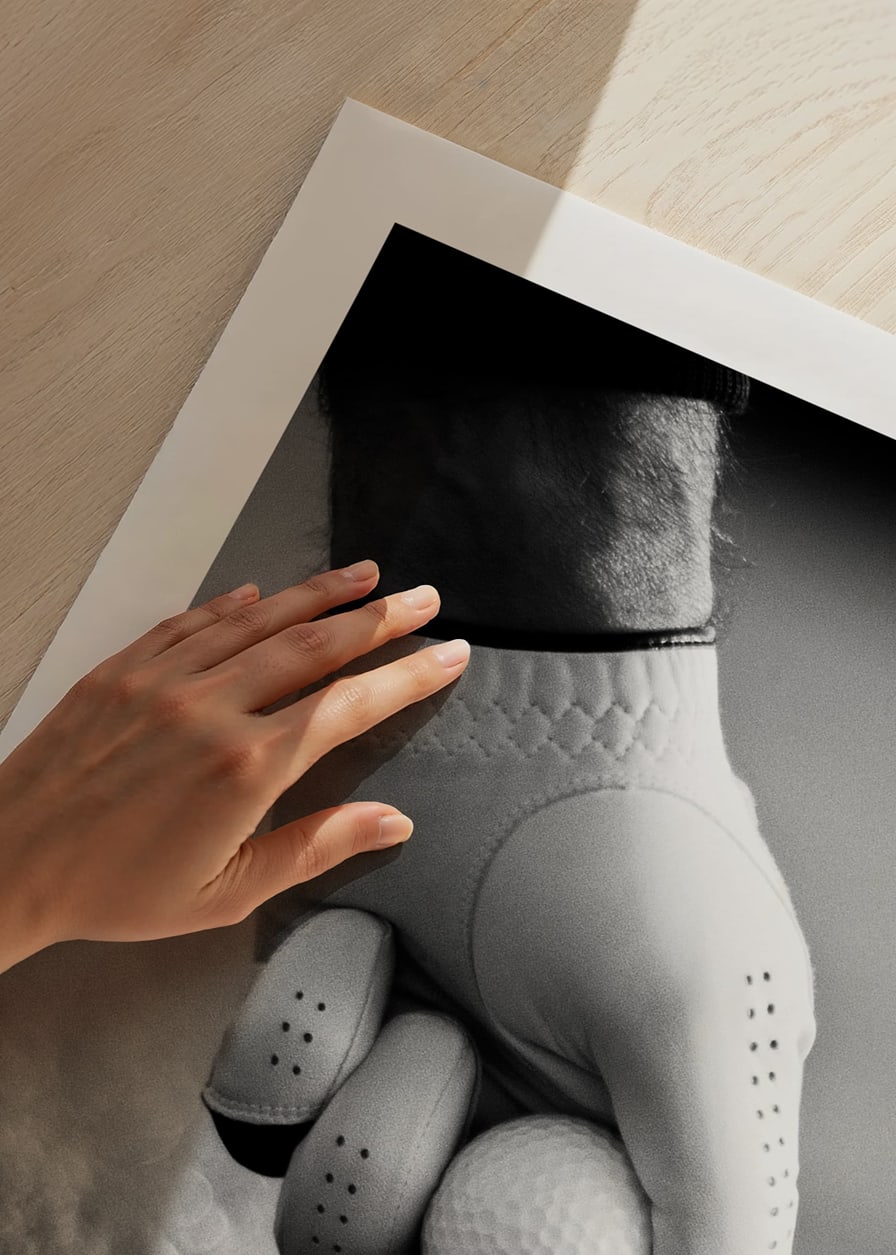 Black and white close-up of hand with golf glove placing ball on tee-12