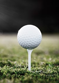Photographic close-up of white golf ball on tee in grass-7