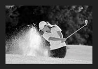 Black and white close-up of golfer in bunker shot, sand is smoking-5