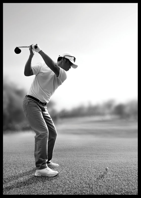Black and white golfer in line with driver on fairway-12