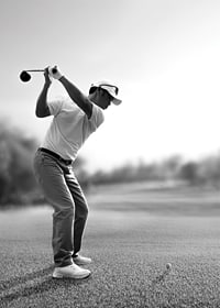 Black and white golfer in line with driver on fairway-7