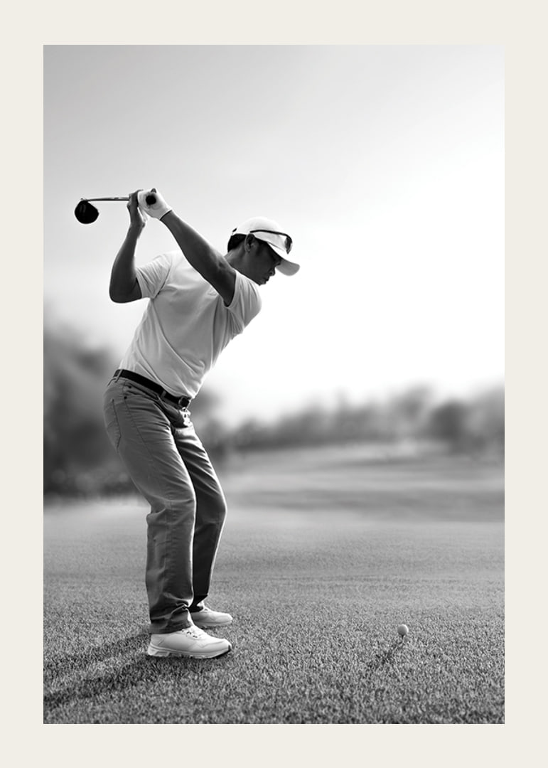 Black and white golfer in line with driver on fairway-12