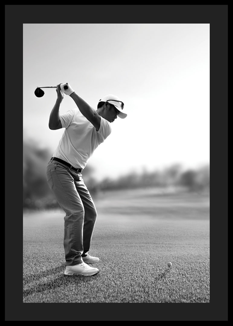 Black and white golfer in line with driver on fairway-12