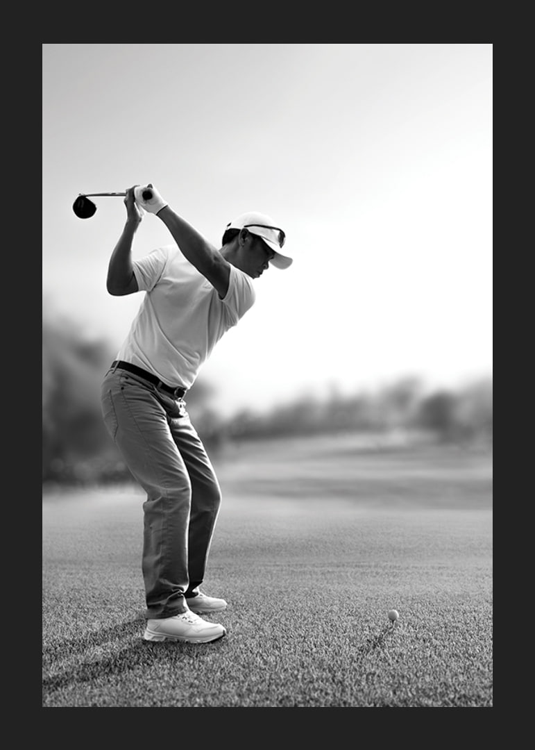 Black and white golfer in line with driver on fairway-12