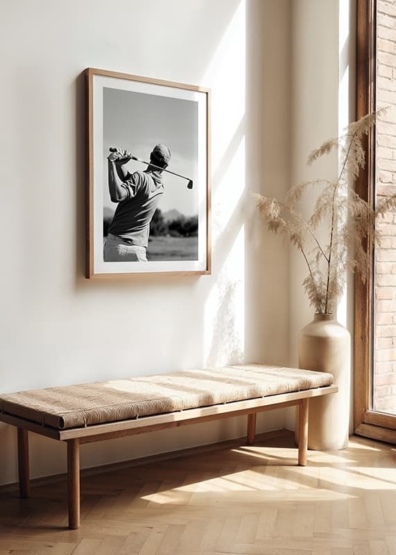 Black and white golfer swinging with club against bright sky-12