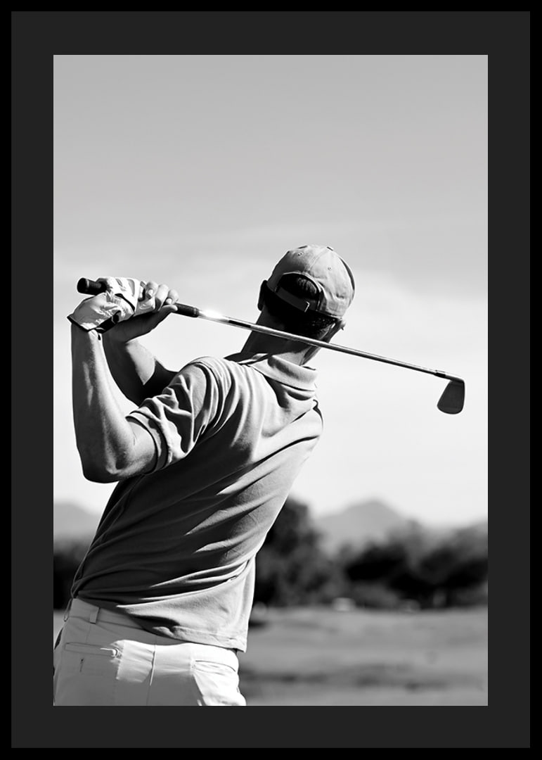 Black and white golfer swinging with club against bright sky-12