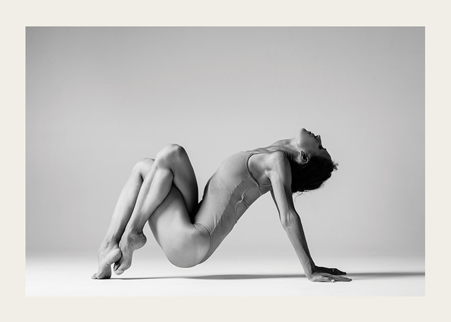 Black and white photo art of woman in yoga position against light background-12