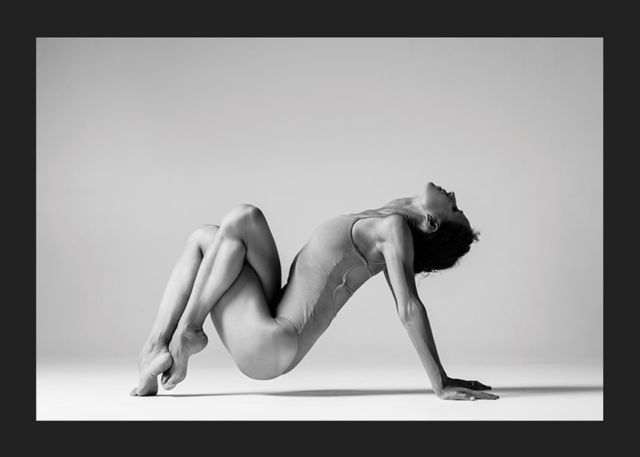 Black and white photo art of woman in yoga position against light background-12