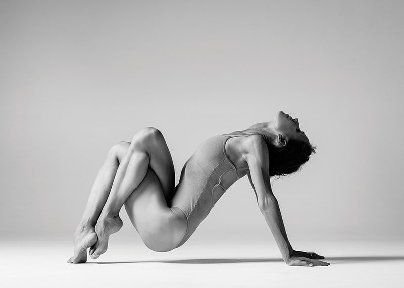 Black and white photo art of woman in yoga position against light background-12