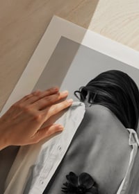 Black and white photograph of woman with flower behind her back-3