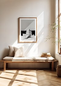 Black and white photo of woman in bathrobe reading newspaper in bed-8