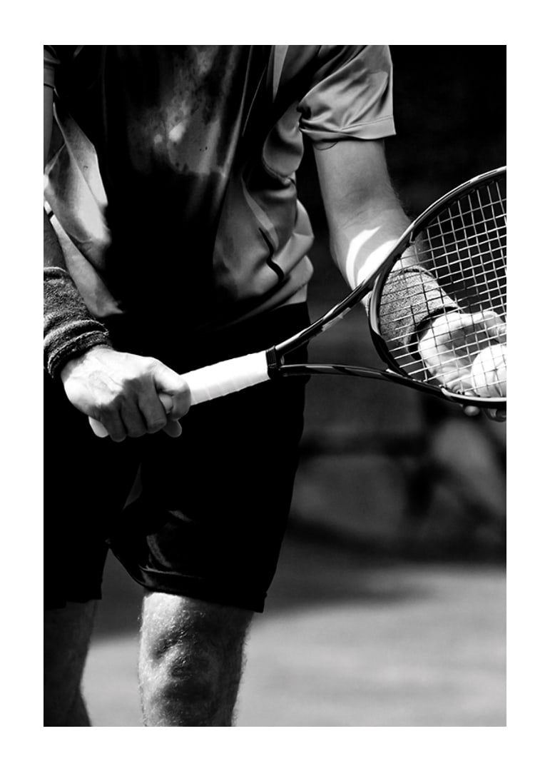Black and white photo of tennis player with racket and ball-12